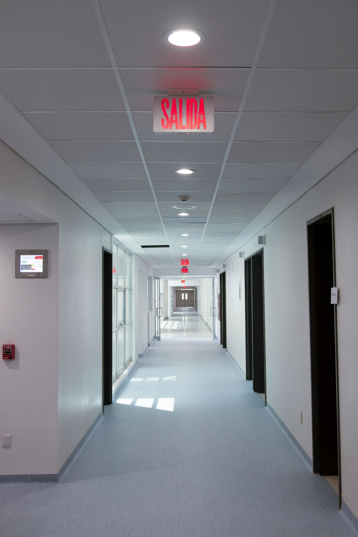 A bright empty healthcare corridor with white walls